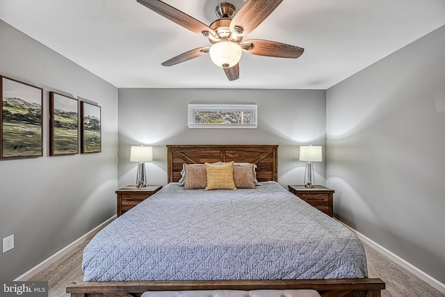 carpeted bedroom with a ceiling fan and baseboards