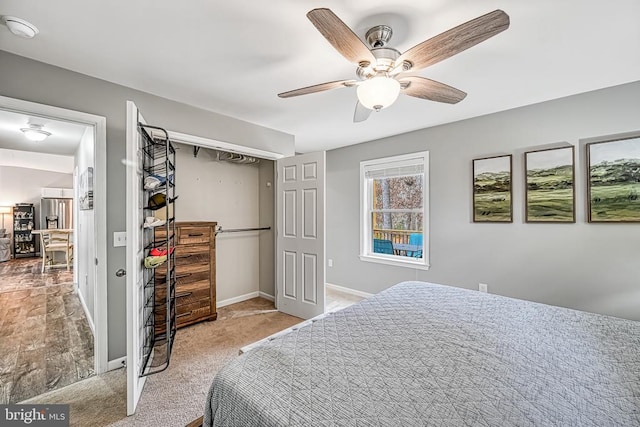 bedroom featuring ceiling fan, a closet, baseboards, and carpet flooring