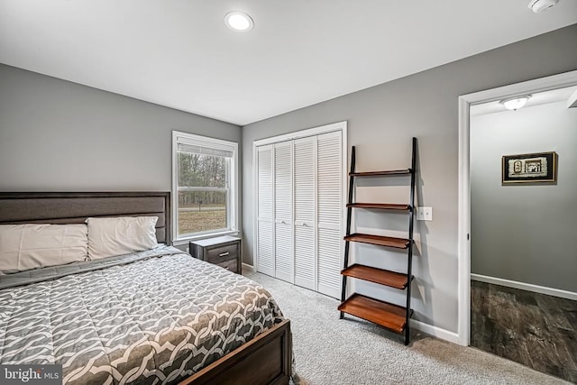 bedroom with carpet, a closet, and baseboards