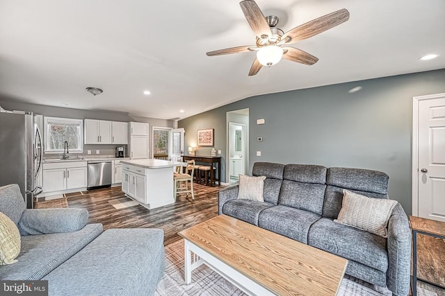 living area featuring lofted ceiling, dark wood-style floors, a ceiling fan, and recessed lighting