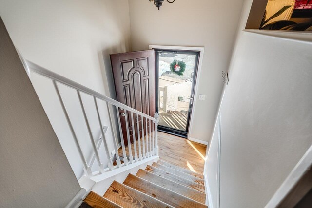 stairs featuring hardwood / wood-style flooring