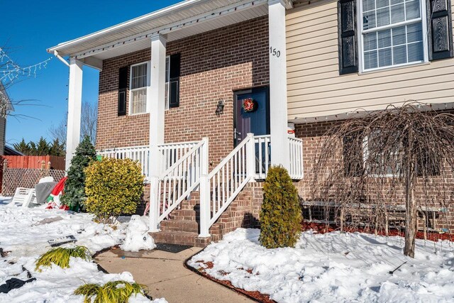 view of snow covered property entrance