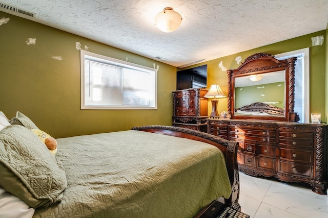 bedroom featuring a textured ceiling