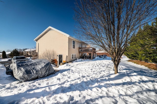 snow covered property featuring a deck