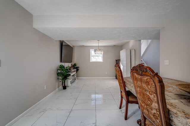 dining space featuring a textured ceiling