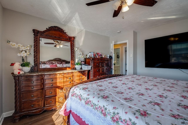 bedroom featuring wood-type flooring, ceiling fan, and a textured ceiling