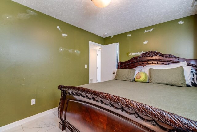 bedroom featuring a textured ceiling