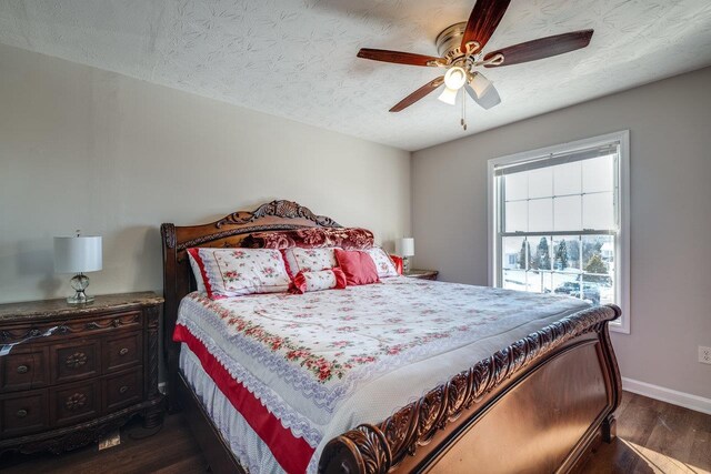 bedroom with dark hardwood / wood-style flooring, ceiling fan, and a textured ceiling