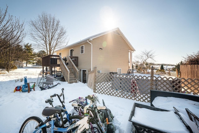 snow covered house featuring a playground