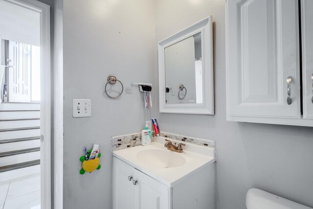 bathroom featuring vanity and toilet