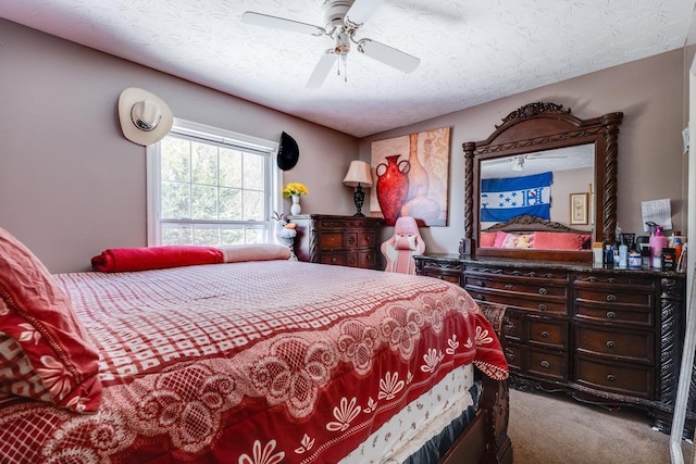 carpeted bedroom featuring ceiling fan and a textured ceiling