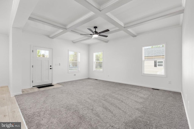 unfurnished living room with beam ceiling, a ceiling fan, coffered ceiling, and baseboards