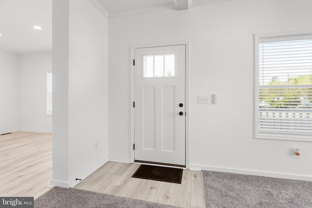 entrance foyer with wood finished floors, crown molding, recessed lighting, and baseboards