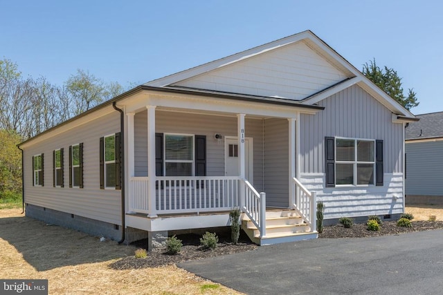 view of front of house with a porch and crawl space