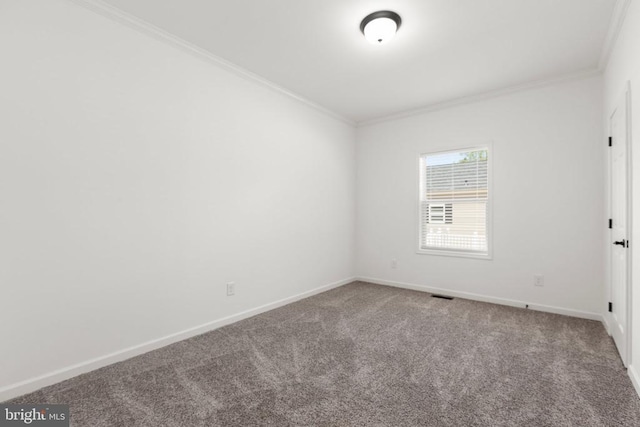carpeted spare room with baseboards, visible vents, and ornamental molding