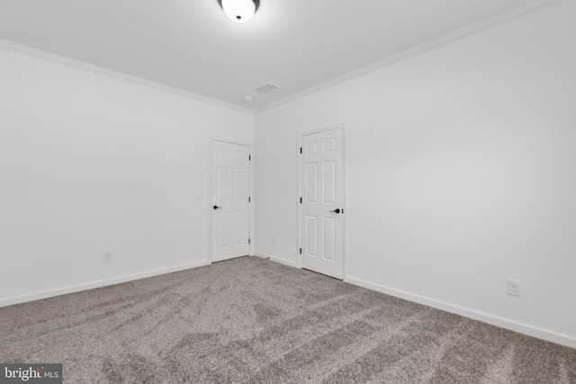 carpeted spare room featuring baseboards and ornamental molding