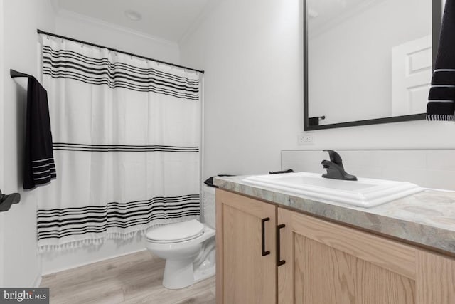 full bath featuring wood finished floors, backsplash, toilet, vanity, and crown molding