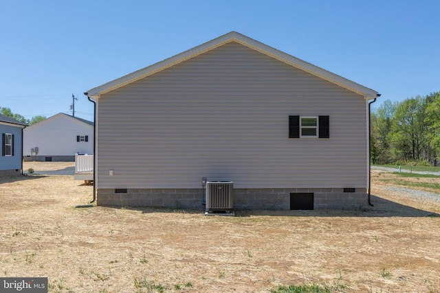 view of property exterior with central air condition unit and crawl space