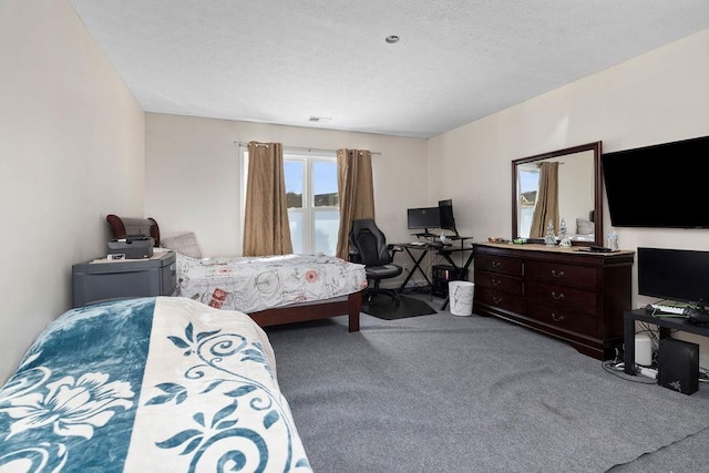 carpeted bedroom with a textured ceiling and visible vents