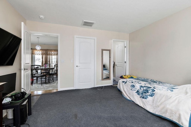 carpeted bedroom featuring visible vents and baseboards