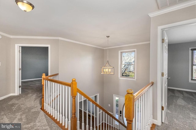 hall with carpet, visible vents, baseboards, and an upstairs landing