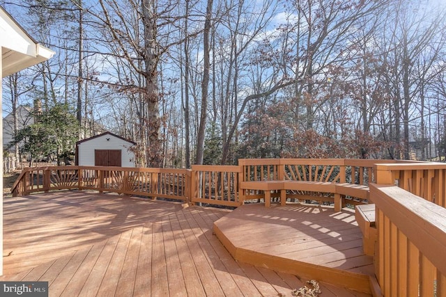 wooden terrace featuring a storage unit and an outdoor structure