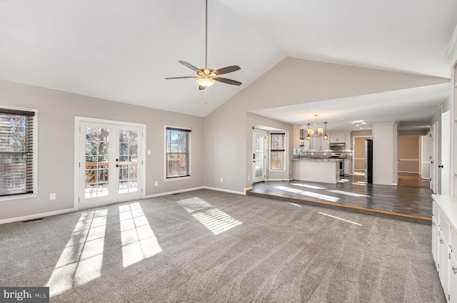 unfurnished living room with high vaulted ceiling, visible vents, baseboards, french doors, and dark carpet