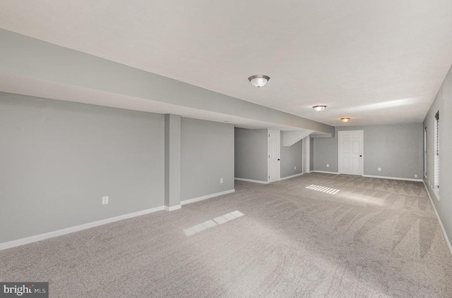 finished basement featuring carpet and baseboards