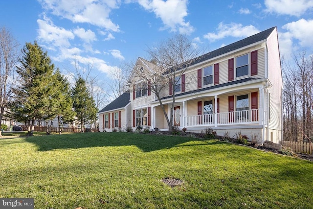 view of front of home with covered porch and a front lawn