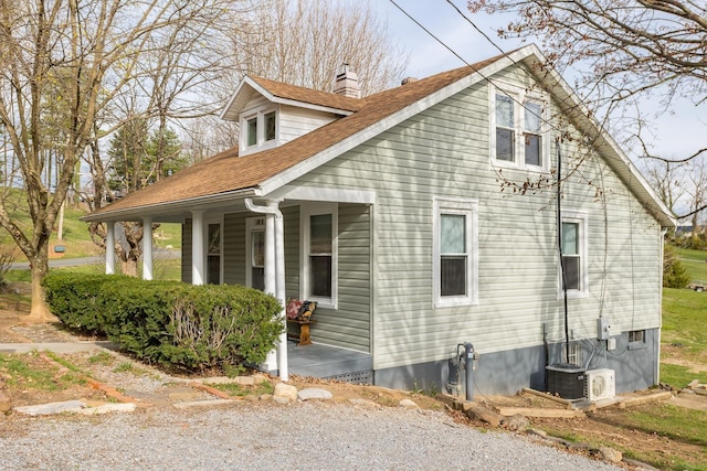 view of side of property with cooling unit and a porch