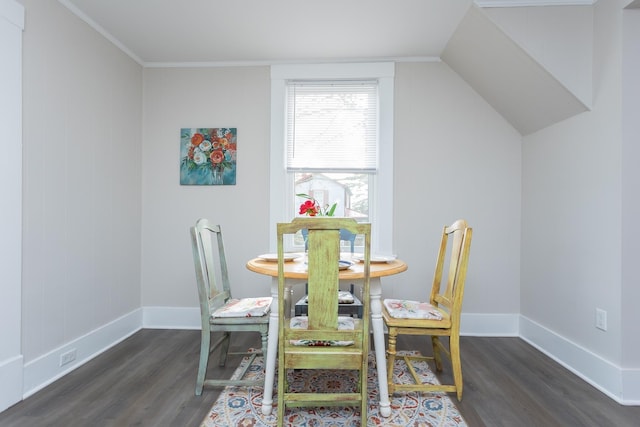 dining room with vaulted ceiling and dark hardwood / wood-style floors