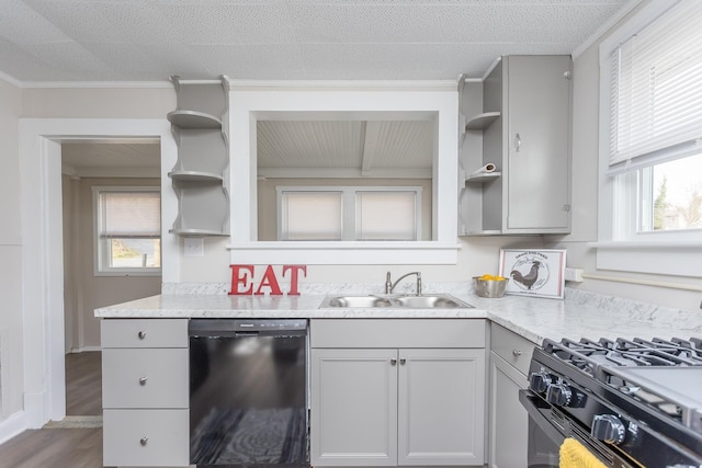 kitchen with hardwood / wood-style floors, sink, ornamental molding, black appliances, and light stone countertops