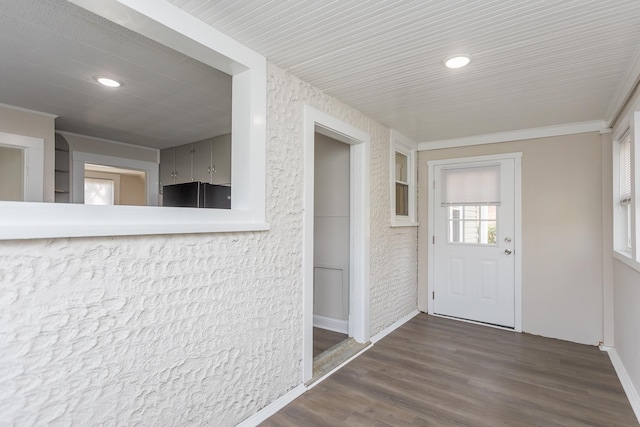 corridor with dark wood-type flooring and ornamental molding