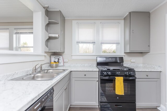 kitchen featuring sink, a wealth of natural light, black appliances, and a textured ceiling