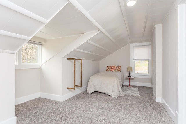 carpeted bedroom featuring vaulted ceiling