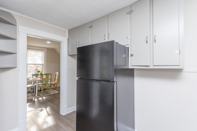 kitchen with black fridge and light hardwood / wood-style floors