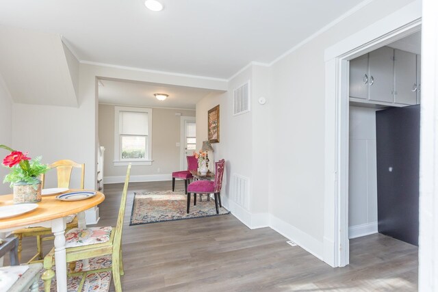 interior space featuring ornamental molding and dark wood-type flooring