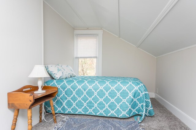 bedroom featuring vaulted ceiling and carpet