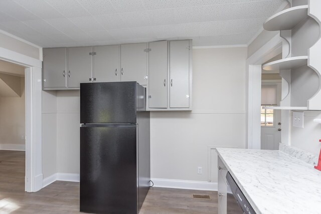 kitchen featuring gray cabinets, black refrigerator, and dark hardwood / wood-style floors