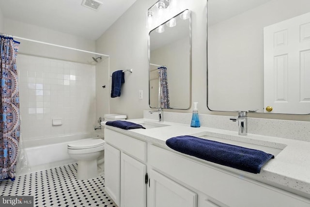 bathroom featuring visible vents, tile patterned flooring, shower / tub combo, vanity, and toilet