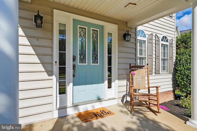 doorway to property featuring covered porch
