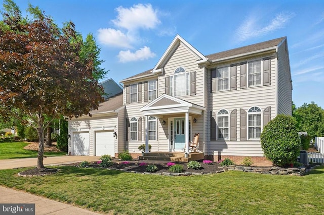 view of front facade featuring an attached garage, driveway, a front yard, and cooling unit