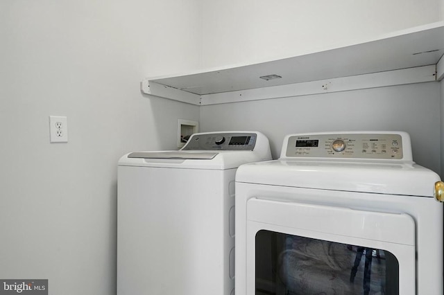 clothes washing area with laundry area and washing machine and clothes dryer
