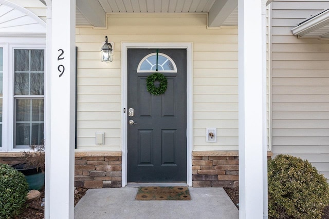 property entrance with stone siding