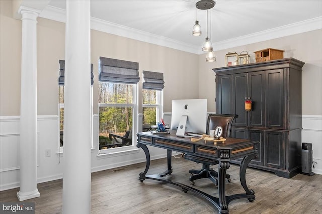 home office with hardwood / wood-style flooring, ornamental molding, and decorative columns