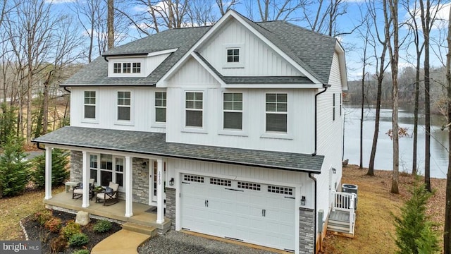 view of front of property with a garage, central AC, a water view, and covered porch