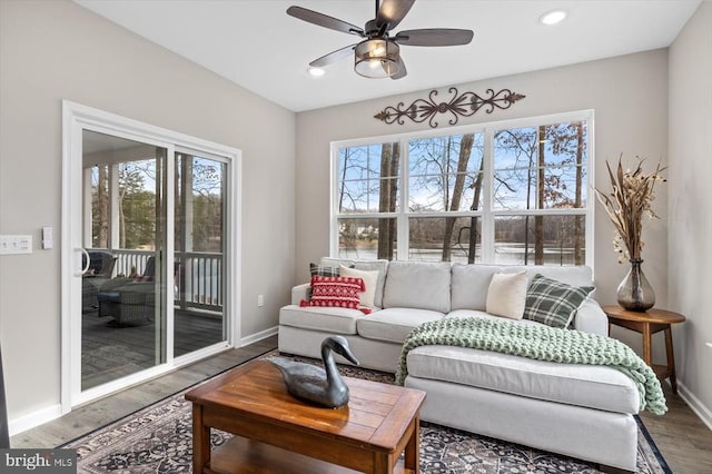 living room featuring hardwood / wood-style floors and ceiling fan