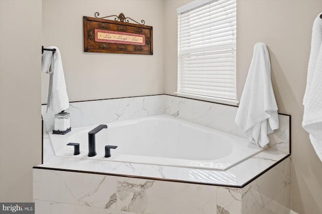 bathroom featuring tiled bath