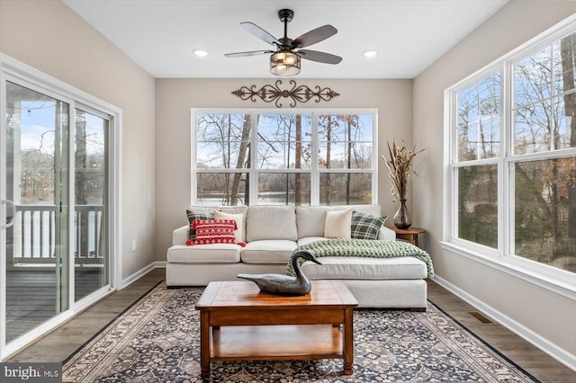 sunroom / solarium featuring ceiling fan