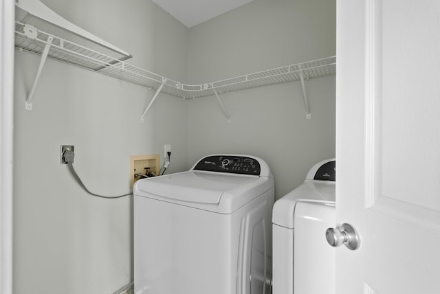 laundry area featuring washing machine and clothes dryer and laundry area